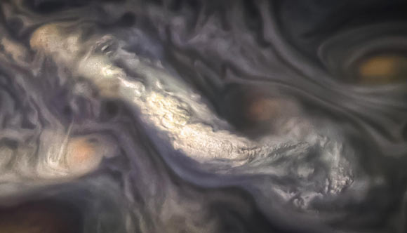 This image captures a high-altitude cloud formation surrounded by swirling patterns in Jupiter’s North North Temperate Belt region. The North North Temperate Belt is one of Jupiter’s many colorful, swirling cloud bands. Scientists have wondered for decades how deep these bands extend. Gravity measurements collected by NASA’s Juno orbiter during its close flybys discovered that these bands of flowing atmosphere actually penetrate deep into the planet, to a depth of about 1,900 miles (3,000 km). Image credit: NASA.