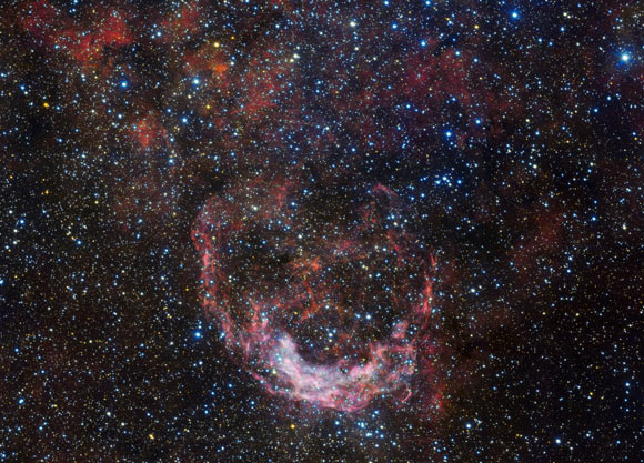 NGC 3199 appears to plough through the star-studded sky like a ship through stormy seas. Image credit: ESO.