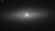 This Hubble image shows the lenticular galaxy NGC 4036. The bright star visible slightly to the right of the galactic center is not within the galaxy itself; it sits between us and NGC 4036, adding a burst of brightness to the scene. The image is a composite of separate exposures acquired by Hubble’s Advanced Camera for Surveys (ACS) instrument. Two filters were used to sample various wavelengths. The color results from assigning different hues to each monochromatic image associated with an individual filter. Image credit: NASA / ESA / Hubble / Judy Schmidt, www.geckzilla.com.