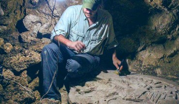 Archaeologist Dr. Marcello Canuto sits beside the ancient Maya altar he and his colleagues discovered in the jungles of northern Guatemala. Image credit: National Museum of Archaeology and Ethnology in Guatemala City / La Corona Regional Archaeological Project.