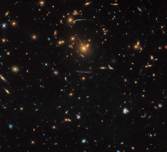 This Hubble image shows a massive group of galaxies bound together by gravity -- a galaxy cluster named SDSS J1050+0017. Image credit: NASA / ESA / Hubble / Judy Schmidt, www.geckzilla.com.