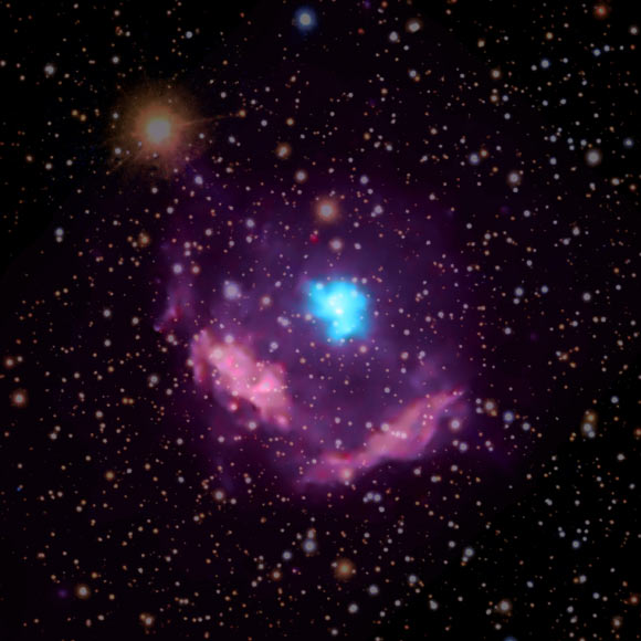 In this composite image of Kes 75, high-energy X-rays observed by Chandra are colored blue and highlight the pulsar wind nebula surrounding the pulsar, while lower-energy X-rays appear purple and show the debris from the explosion. Image credit: X-rays – NASA / CXC / NCSU / S. Reynolds; optical – PanSTARRS.