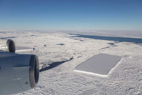 Just past the rectangular iceberg, which is visible from behind the outboard engine, IceBridge saw another relatively rectangular iceberg. Image credit: Jeremy Harbeck, NASA.