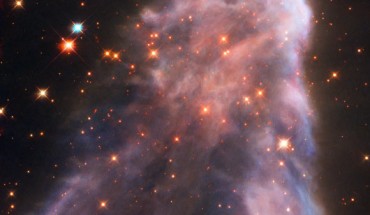IC 63 is classified as both a reflection nebula (as it is reflecting the light of a nearby star) and as an emission nebula (as it releases hydrogen-alpha radiation); both effects are caused by the gigantic star Gamma Cassiopeiae; the radiation of this star is also slowly causing the nebula to dissipate. Image credit: NASA / ESA / Hubble.