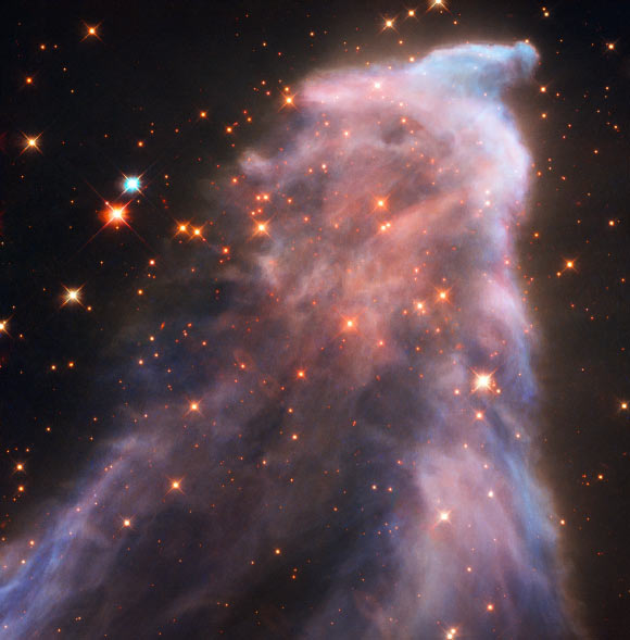 IC 63 is classified as both a reflection nebula (as it is reflecting the light of a nearby star) and as an emission nebula (as it releases hydrogen-alpha radiation); both effects are caused by the gigantic star Gamma Cassiopeiae; the radiation of this star is also slowly causing the nebula to dissipate. Image credit: NASA / ESA / Hubble.