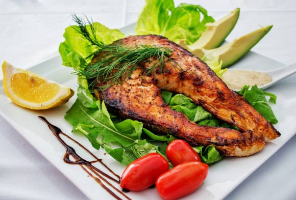Eating fish such as salmon, trout and sardines as part of a healthy diet can reduce asthma symptoms in children. Image credit: Dana Tentis.