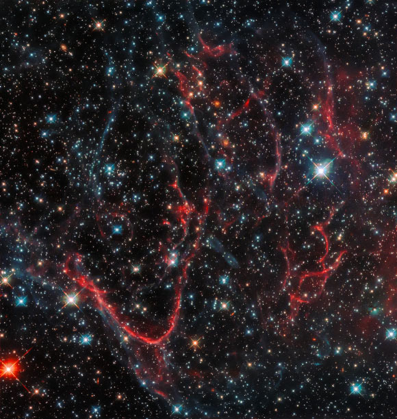 This Hubble image shows a supernova remnant called SNR 0454-67.2. The color image was made from separate exposures taken in the visible region of the spectrum with Hubble’s Wide Field Camera 3 (WFC3). Four filters were used to sample various wavelengths. The color results from assigning different hues to each monochromatic image associated with an individual filter. Image credit: NASA / ESA / Hubble.