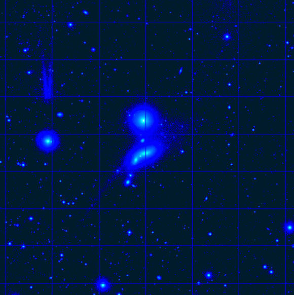 This image shows the HCG 98 group. The core of HCG 98 consists of the two ‘smudges’ at the center of the image. Each is a galaxy much like our own Milky Way Galaxy. The tadpole structure covers the central galaxy pair and was formed when the pair demolished a much smaller galaxy. Image credit: Brosch et al, doi: 10.1093/mnras/sty2717.
