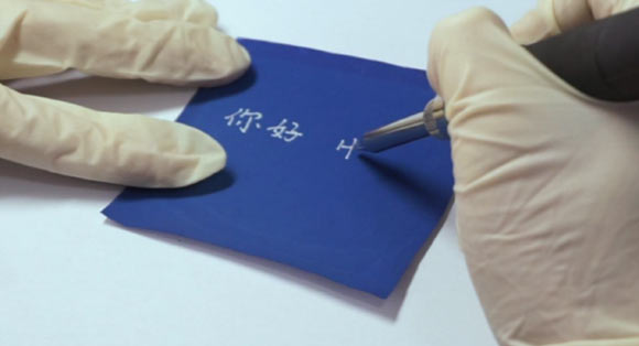 Chen et al’s rewritable paper demonstrates excellent rewriting performances (legible time > 6 months and reversibility > 100 times); its color rapidly changes from blue to colorlessness when the temperature is higher than 149 degrees Fahrenheit (65 degrees Celsius), and the colorless state can be maintained at room temperature; the color returns to blue when the temperature is lower than 14 degrees Fahrenheit (minus 10 degrees Celsius). Image credit: Chen et al, doi: 10.1021/acsami.8b14625.