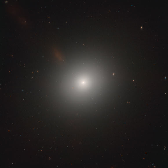 This new image from Hubble shows an elliptical galaxy called Messier 105. Image credit: NASA / ESA / Hubble / C. Sarazin et al.