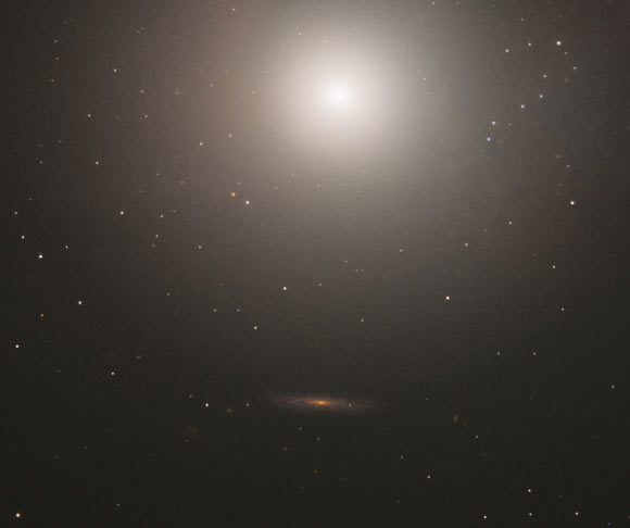 This image of the elliptical galaxy Messier 89 is a composite of separate exposures acquired by Hubble’s Wide Field and Planetary Camera 2 (WFPC2). Two filters were used to sample various wavelengths. The color results from assigning different hues to each monochromatic image associated with an individual filter. Image credit: NASA / ESA / Hubble / S. Faber et al.