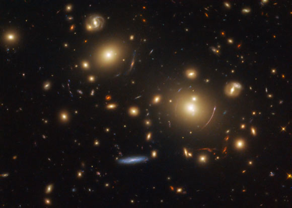 This Hubble image shows a giant cluster of galaxies called SDSS J0928+2031. The image is made up of observations from Hubble’s Wide Field Camera 3 (WFC3) in the infrared and optical parts of the spectrum. It is based on data obtained through four filters. The color results from assigning different hues to each monochromatic image associated with an individual filter. The image was made as part of the Sloan Giant Arcs Survey Program. Image credit: NASA / ESA / Hubble / M. Gladders et al / Judy Schmidt, www.geckzilla.com.