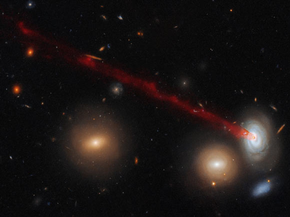 This striking image combines data gathered with Hubble’s Advanced Camera for Surveys (ACS) and data from the Subaru Telescope in Hawaii. It shows just a part of the spectacular tail emerging from the spiral galaxy D100. Image credit: NASA / ESA / Hubble / Cramer et al.