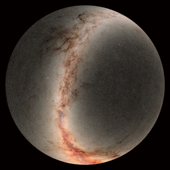 This image is a mosaic of photographs taken by the Pan-STARRS Observatory. The center of the circle is the north celestial pole, and the outer edge is a sky declination of minus 30 degrees -- the southern horizon as seen in Hawai’i. The bright band extending from top to bottom is our Milky Way Galaxy. The center of the galaxy is near the bottom edge of the image where the galaxy is brightest. In total, Pan-STARRS catalogued more than 800 million objects within this image. The image includes both stars and galaxies, although most of what is visible are objects in the Milky Way. In the plane of the Milky Way, dark filaments and clouds show cosmic dust, which absorbs blue light and makes the objects appear much redder. The Pan-STARRS data have been used to produce the best map of our Galaxy’s dust by analyzing the colors and brightnesses of these stars. Image credit: R. White, STScI / PS1 Science Consortium, Brooks Bays.