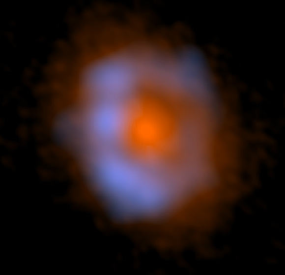 False-color image of V883 Orionis taken with ALMA. The distribution of dust is shown in orange and the distribution of methanol is shown in blue. Image credit: ALMA / ESO / NAOJ / NRAO / Lee et al.