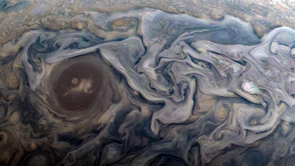 This new image from Juno shows swirling clouds in a jet stream region called Jet N6. The image was taken at 12:20 p.m. EST (9:20 a.m. PST) on February 12, 2019, as the spacecraft performed its 18th close flyby of the gas giant. At the time, Juno was about 8,000 miles (13,000 km) from the planet’s cloud tops, above a latitude of approximately 55 degrees north. Image credit: NASA / JPL-Caltech / SwRI / MSSS / Kevin M. Gill.