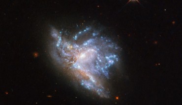This Hubble image shows two interacting galaxies, known collectively as NGC 6052. The picture was snapped by Hubble’s Wide Field Camera 3 (WFC3). Five filters were used to sample various wavelengths. The color results from assigning different hues to each monochromatic image associated with an individual filter. Image credit: NASA / ESA / Hubble / A. Adamo et al.