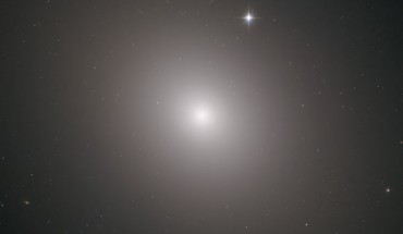 This Hubble image shows the elliptical galaxy Messier 49. The image was made from separate exposures taken in the visible and infrared regions of the spectrum with Hubble’s Advanced Camera for Surveys (ACS) and Wide Field Camera 3 (WFC3). Four filters were used to sample various wavelengths. The color results from assigning different hues to each monochromatic image associated with an individual filter. Image credit: NASA / ESA / Hubble / J. Blakenslee / P Cote et al.