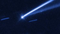 The asteroid (6478) Gault is seen with the NASA/ESA Hubble Space Telescope, showing two narrow, comet-like tails of debris that tell us that the asteroid is slowly undergoing self-destruction. The bright streaks surrounding the asteroid are background stars. Image credit: NASA / ESA / K. Meech & J. Kleyna, University of Hawaii / O. Hainaut, European Southern Observatory.