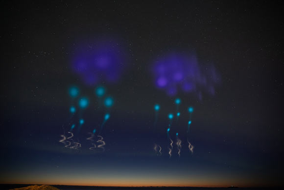 Colorful clouds formed by the release of vapors from the two AZURE rockets allow scientists to measure auroral winds. Image credit: Lee Wingfield / NASA.