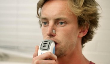 A volunteer demonstrates Inspiratory Muscle Strength Training. Image credit: University of Colorado Boulder.