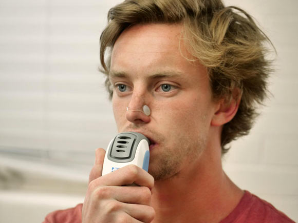 A volunteer demonstrates Inspiratory Muscle Strength Training. Image credit: University of Colorado Boulder.