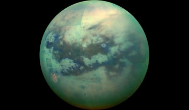 A false-color view of Titan, a moon of Saturn surrounded by a thick orange haze. Image credit: NASA / JPL / University of Arizona / University of Idaho.