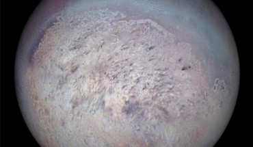 Voyager 2 image of Triton showing the south polar region with dark streaks produced by geysers visible on the icy surface. Image credit: NASA / JPL.