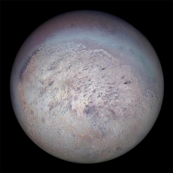 Voyager 2 image of Triton showing the south polar region with dark streaks produced by geysers visible on the icy surface. Image credit: NASA / JPL.