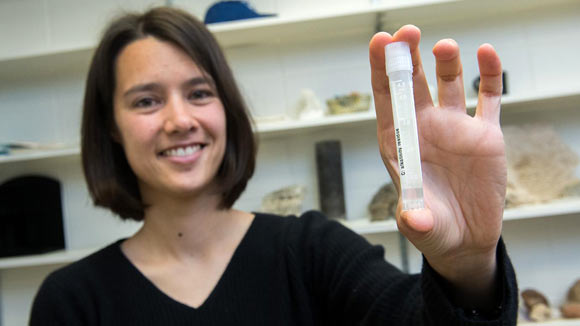 Dr. Blättler with a vial of 20,000-year-old seawater. Image credit: Jean Lachat.