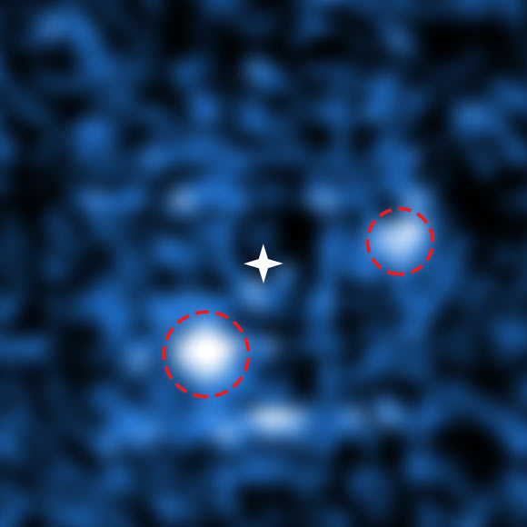 PDS 70 is only the second multi-planet system to be directly imaged. Through a combination of adaptive optics and data processing, Haffert et al were able to cancel out the light from the central star (marked by a white star) to reveal two orbiting protoplanets. PDS 70 b (lower left) weighs 4 to 17 times as much as Jupiter while PDS 70 c (upper right) weighs 1 to 10 times as much as Jupiter. Image credit: ESO / S. Haffert, Leiden Observatory.