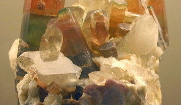 This image shows tri-color crystals of elbaite, a mineral species belonging to the tourmaline group, on quartz. Image credit: Reno Chris.