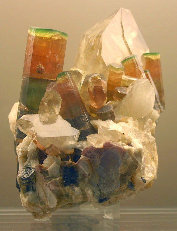 This image shows tri-color crystals of elbaite, a mineral species belonging to the tourmaline group, on quartz. Image credit: Reno Chris.