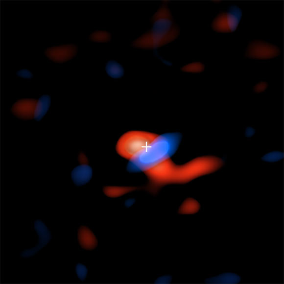 ALMA image of the disk of cool hydrogen gas flowing around the supermassive black hole at the center of our Galaxy. The colors represent the motion of the gas relative to Earth: the red portion is moving away, so the radio waves detected by ALMA are slightly stretched, or shifted, to the ‘redder’ portion of the spectrum; the blue color represents gas moving toward Earth, so the radio waves are slightly scrunched, or shifted, to the ‘bluer’ portion of the spectrum. Image credit: ALMA / ESO / NAOJ / NRAO / E.M. Murchikova / AUI / NSF / S. Dagnello.