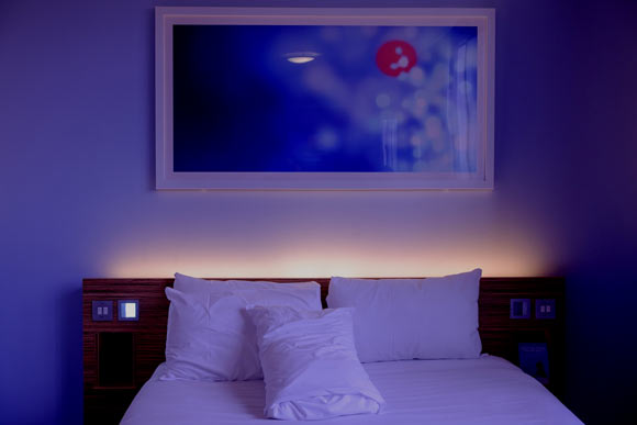 Sleeping with a TV or artificial light on may be a risk factor for gaining weight or developing obesity. Image credit: Pexels.