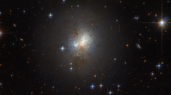 This Hubble image shows the dwarf starburst galaxy ESO 495-21. The galaxy is just 3,000 light-years across, a fraction of the size of the Milky Way, but that is not stopping the galaxy from furiously forming huge numbers of stars. This image is a composite of separate exposures acquired by Hubble’s Wide Field Planetary Camera 2 (WFPC2) and Advanced Camera for Surveys (ACS) instruments. Image credit: NASA / ESA / Hubble.