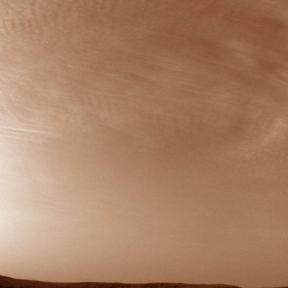 NASA’s Mars rover Curiosity imaged these drifting clouds on May 7, 2019. These are likely water-ice clouds about 19 miles (31 km) above the surface. Image credit: NASA / JPL-Caltech.