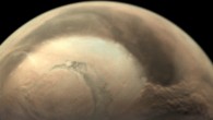 A dust storm underway at the edge of the north polar ice cap of Mars. The image was taken by Mars Express’ Visual Monitoring Camera on May 29, 2019. Image credit: ESA / GCP / UPV / EHU Bilbao.