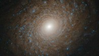 This Hubble image shows the multi-armed spiral galaxy NGC 2985. The color image was made from separate exposures taken in the visible and near-infrared regions of the spectrum with Hubble’s Advanced Camera for Surveys (ACS). It is based on data obtained through two filters: F658W and F814W. The color results from assigning different hues to each monochromatic image associated with an individual filter. Image credit: NASA / ESA / Hubble / L. Ho.