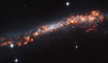 This Hubble image shows the edge-on distorted spiral galaxy NGC 3432. The color image was made from separate exposures taken in the visible region of the spectrum with Hubble’s Advanced Camera for Surveys (ACS). Two filters were used to sample various wavelengths. The color results from assigning different hues to each monochromatic image associated with an individual filter. Image credit: NASA / ESA / Hubble / A. Filippenko / R. Jansen.