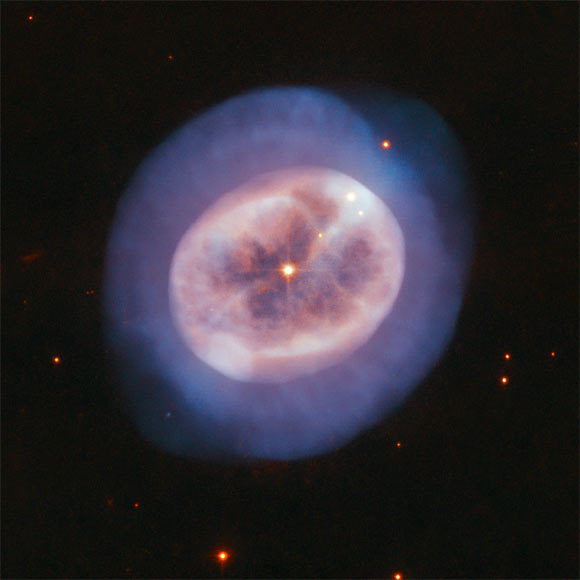 This image, taken with Hubble’s Advanced Camera for Surveys (ACS), shows the planetary nebula NGC 2022. The color composite was assembled from images taken in visible and infrared light. Two filters were used to sample various wavelengths. The color results from assigning different hues to each monochromatic image associated with an individual filter. Image credit: NASA / ESA / Hubble / R. Wade.