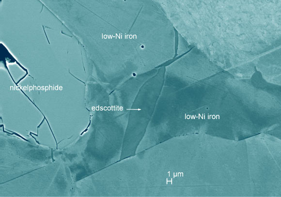 Scanning electron microscopy image (colorized) showing edscottite in the polished Wedderburn section from the UCLA Meteorite Collection. Image credit: Ma & Rubin, doi: 10.2138/am-2019-7102.