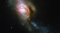 This Hubble image shows NGC 4194, an ongoing cosmic collision between two galaxies. This picture was snapped by Hubble’s Wide Field Camera 3 (WFC3). The image was made through four filters. The color results from assigning different hues to each monochromatic image associated with an individual filter. Image credit: NASA / ESA / Hubble / A. Adamo.