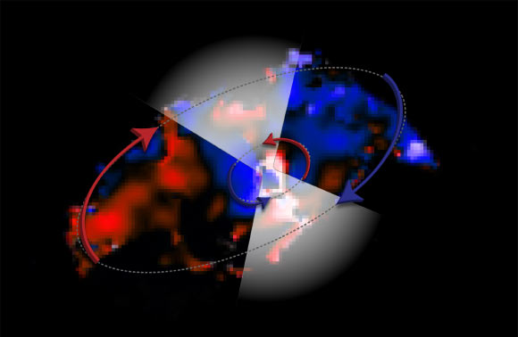 This ALMA image shows two disks of gas moving in opposite directions around the black hole in Messier 77. The colors in this image represent the motion of the gas: blue is material moving toward us, red is moving away. The white triangles are added to show the accelerated gas that is expelled from the inner disk, forming a thick, obscuring cloud around the black hole. Image credit: ALMA / ESO / NAOJ / NRAO / V. Impellizzeri / AUI / NSF / S. Dagnello.
