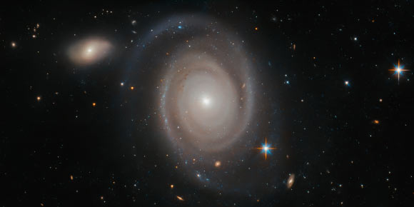 This Hubble image shows the face-on spiral galaxy NGC 1706. The color image was made from separate exposures taken in the visible and infrared regions of the spectrum with Hubble’s Advanced Camera for Surveys (ACS). Two filters were used to sample various wavelengths. The color results from assigning different hues to each monochromatic image associated with an individual filter. Imager credit: NASA / ESA / Hubble / A. Bellini et al.