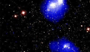 This composite image shows Abell 1758, a quadruple galaxy cluster system about 3 billion light-years away from Earth. In the northern (top) pair seen in the image, the centers of each cluster have already passed by each other once, about 300 to 400 million years ago, and will eventually swing back around. The southern pair at the bottom of the image has two clusters that are close to approaching each other for the first time. X-rays from Chandra are shown as blue and white, depicting fainter and brighter diffuse emission, respectively. This image also includes an optical image from the Sloan Digital Sky Survey (SDSS). Image credit: NASA / CXC / SAO / G. Schellenberger et al / SDSS.