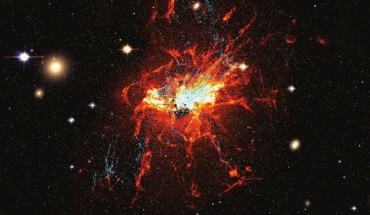 This Hubble image shows young globular clusters (blue) and filaments of cool gas (red) around NGC 1275 in the center of the Perseus cluster (also known as Abell 426), a group of over 1,000 galaxies located 240 million light-years from Earth. Image credit: Lim et al, doi: 10.1038/s41550-019-0909-6.