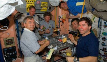 The Expedition 20 crew members share a meal in the Unity node of the International Space Station. Image credit: NASA.