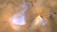 The yellow-white cloud in the bottom-center of this image, taken on November 30, 2010 by NASA’s Mars Reconnaissance Orbiter, is a ‘dust tower’ -- a concentrated cloud of dust that can be lofted dozens of miles above the surface. The blue-white plumes are water vapor clouds. Image credit: NASA / JPL-Caltech / MSSS.
