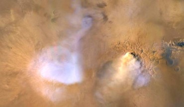 The yellow-white cloud in the bottom-center of this image, taken on November 30, 2010 by NASA’s Mars Reconnaissance Orbiter, is a ‘dust tower’ -- a concentrated cloud of dust that can be lofted dozens of miles above the surface. The blue-white plumes are water vapor clouds. Image credit: NASA / JPL-Caltech / MSSS.